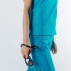 Doamna doctor ce poarta o bluza de scrub medical albastru azure.Uniforma medicala albastru azure este din bumbac 95% si elastan 5% cu croiala fit.